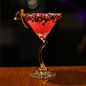 pink cocktail in swirly martini glass